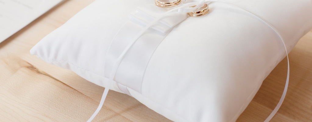 Smiling little girl hugs pillow