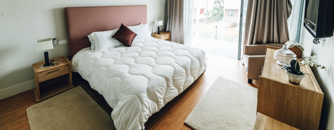 She squats and looks at the mattress